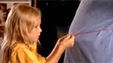 A girl measures her father's waist
