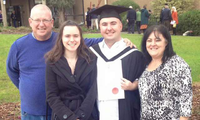 Trent with his mum, dad and sister at his graduation in 2015.