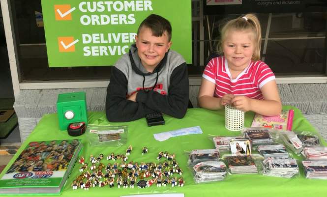 Kyen with sister Piper, who helped by sorting the cards while her brother made sales.