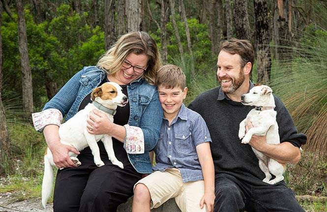 Emma with her son Gus, husband Ben and their two dogs.