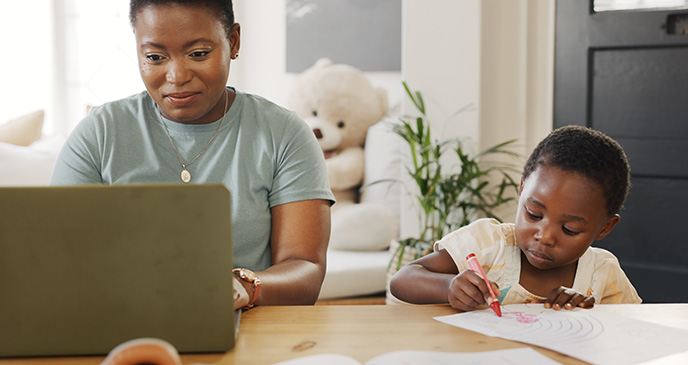 Mother daughter working at dining table