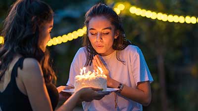 A girl blowing out candles