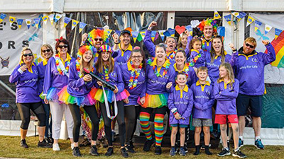 People wearing Relay For Life uniforms, one with a daffodil hood