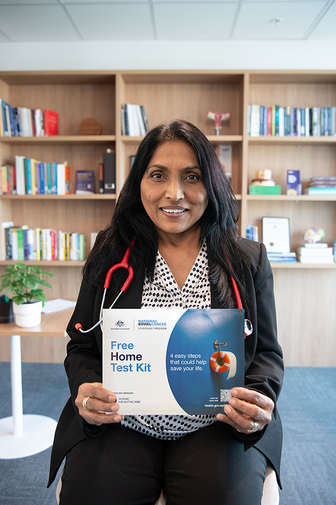 Dr Pallavi Sharma holding a bowel screening kit