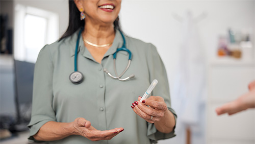 Image of health professional holding cervical test