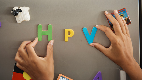 Image of the letters H P V on a fridge