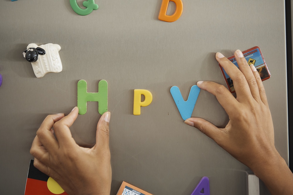 The letters H P V on a fridge